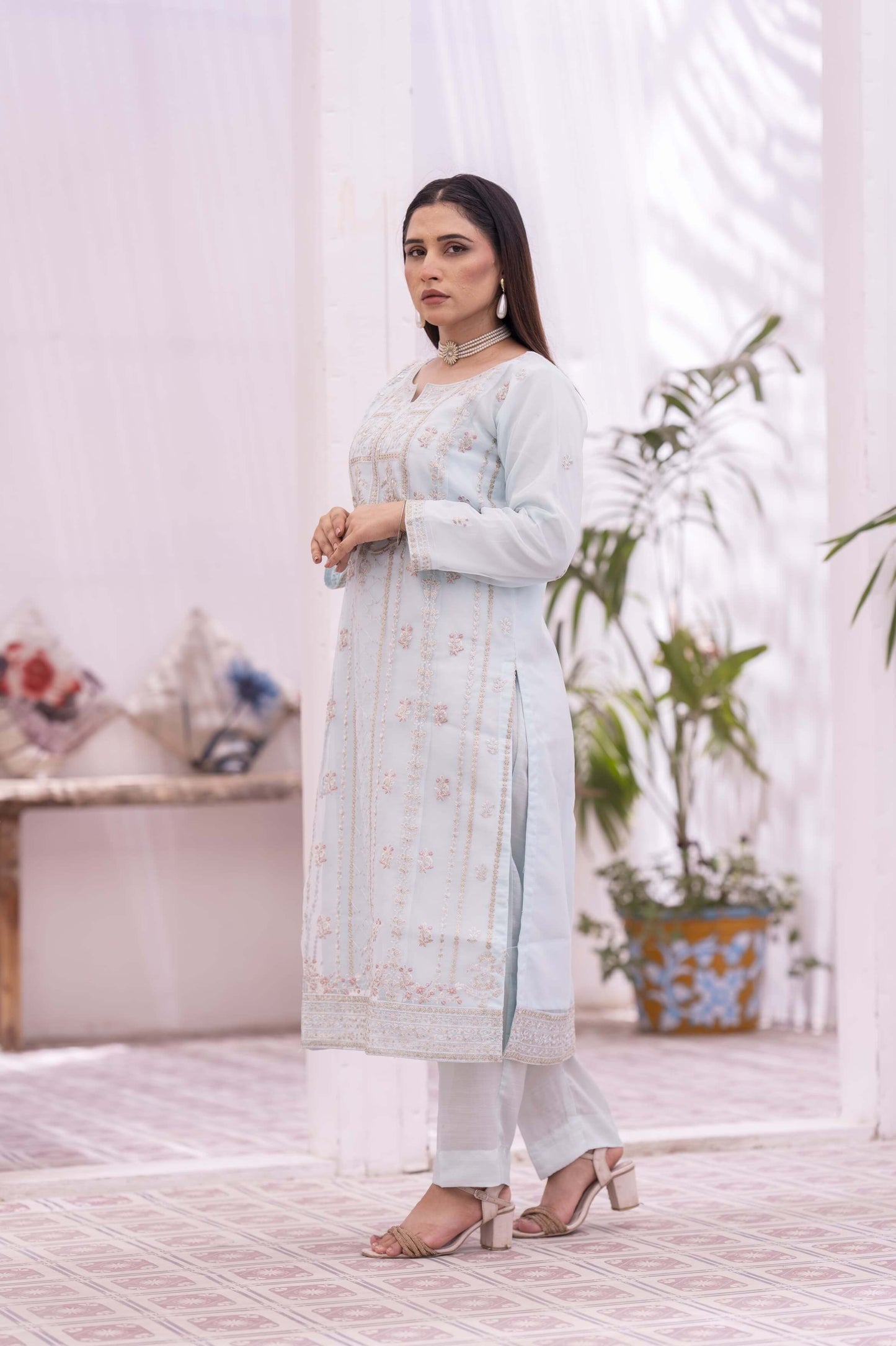 Woman in a light blue traditional shalwar kameez