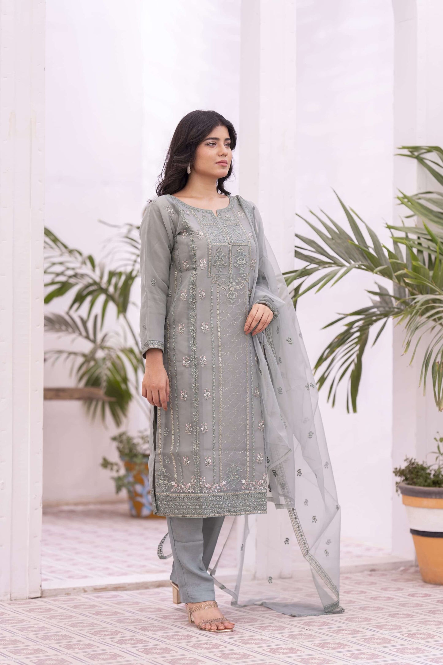 Woman wearing a light green traditional organza outfit with a dupatta
