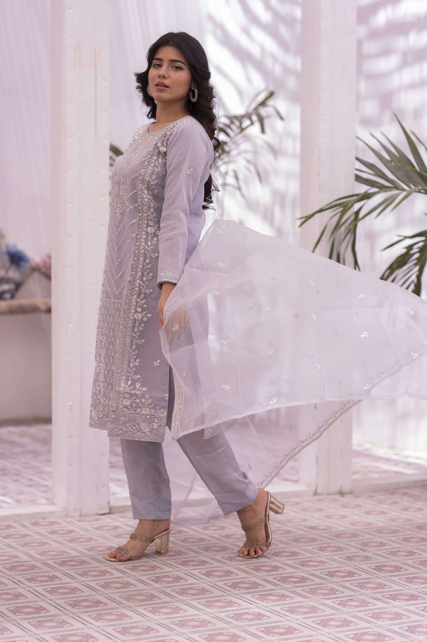 Woman in a lilac traditional outfit with a dupatta