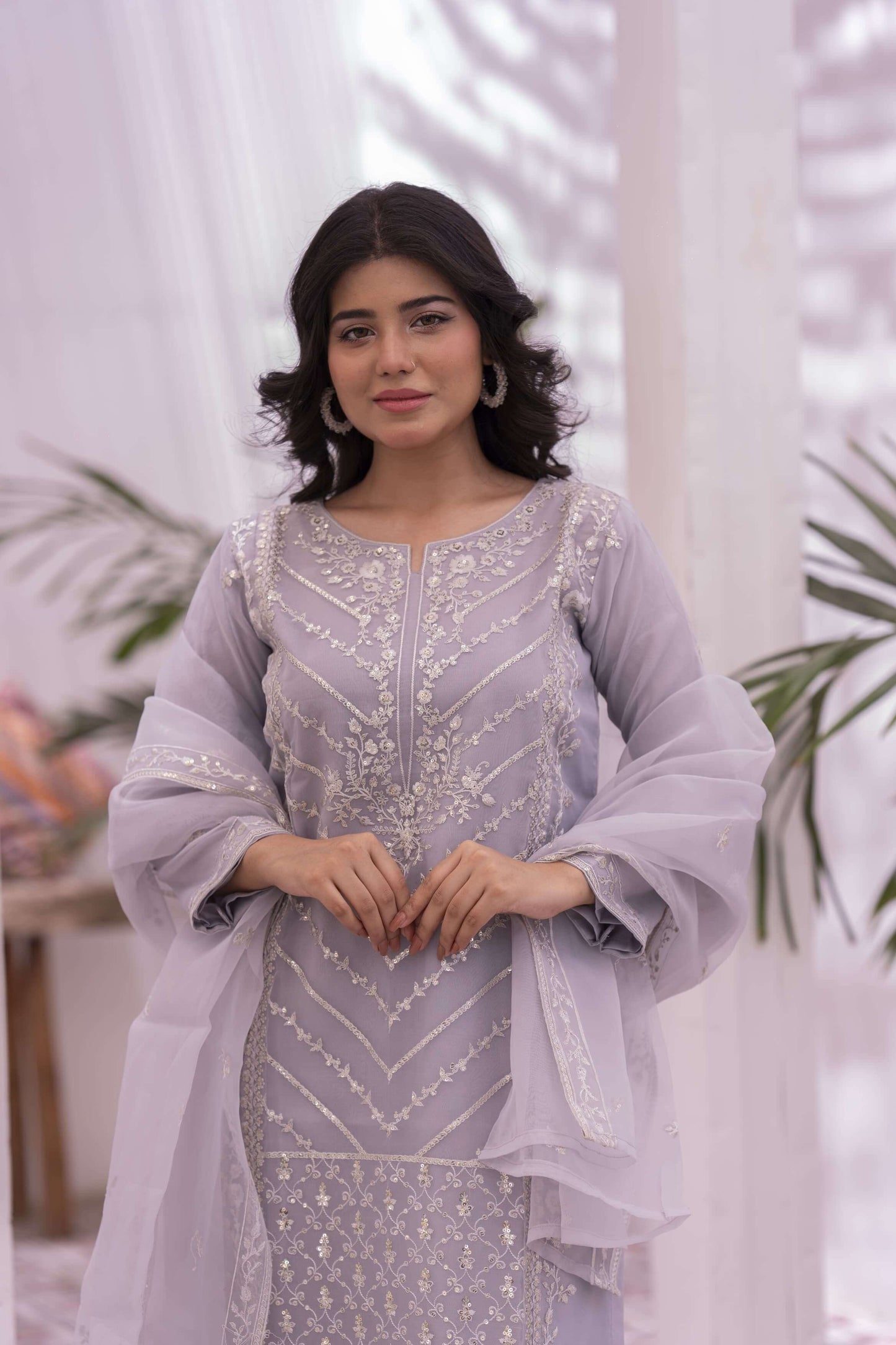 Woman wearing a light purple embroidered outfit with dupatta