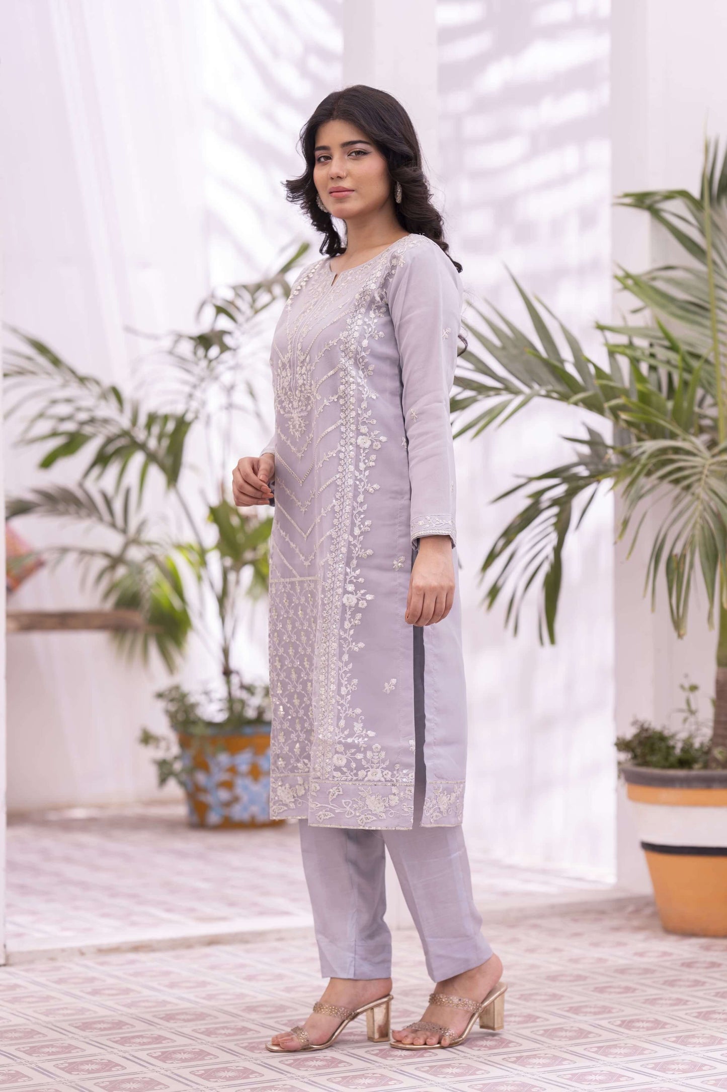 Woman in a light purple traditional outfit side profile