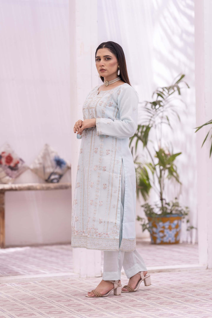 Woman in a light blue traditional shalwar kameez