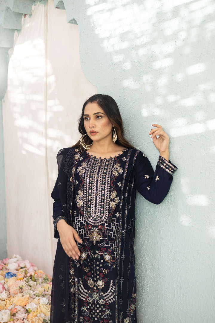 Woman wearing a dark blue chiffon embroidered Shalwar Kameez