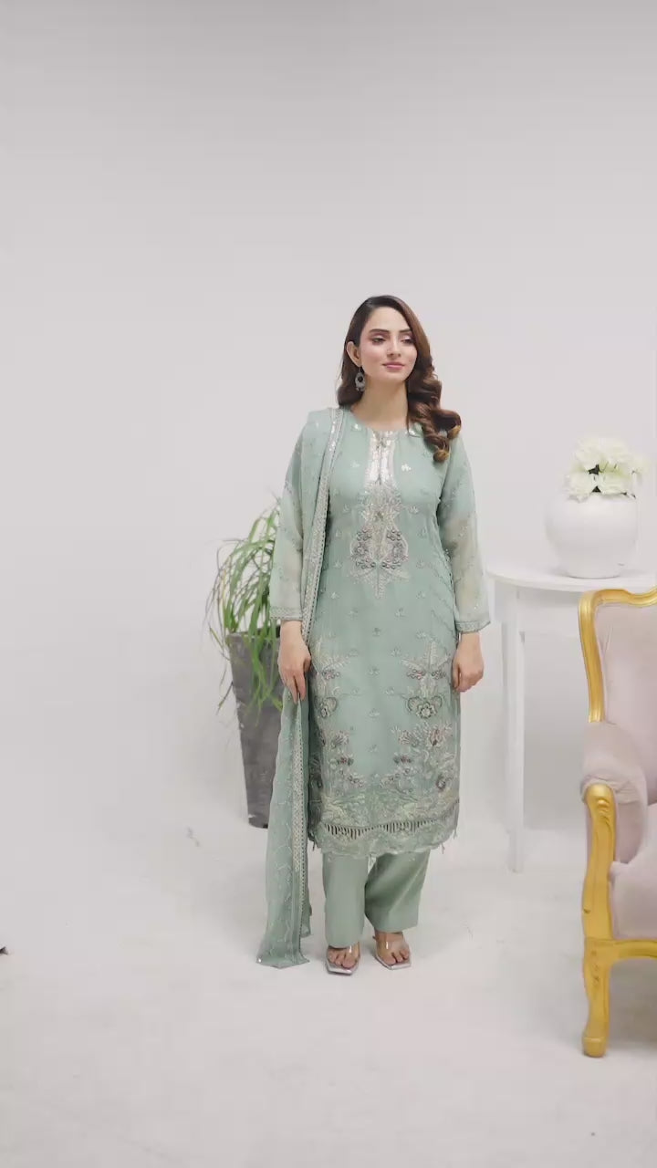 Model wearing mint chiffon shalwar kameez set with graceful embroidery, showing movement, drape, and styling of the dupatta.