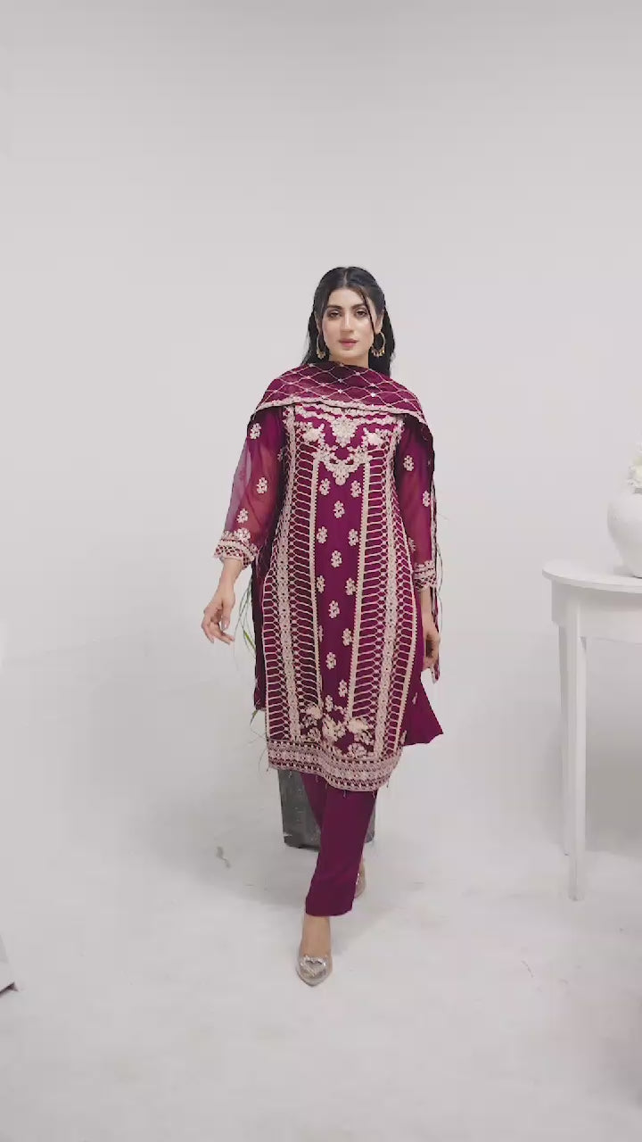 Woman wearing a magenta embroidered chiffon salwar kameez video
