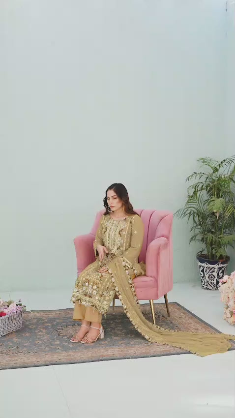 Woman in a light mustard traditional chiffon shalwar kameez outfit video